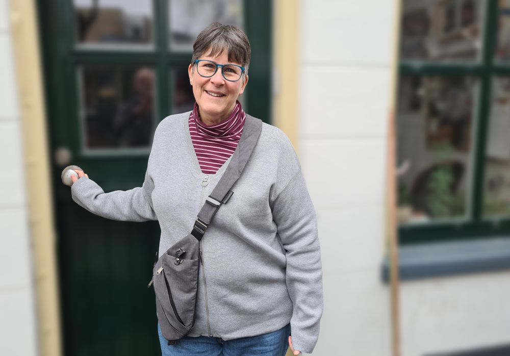 A picture of me wearing a triangular cross-body bag designed for travel.