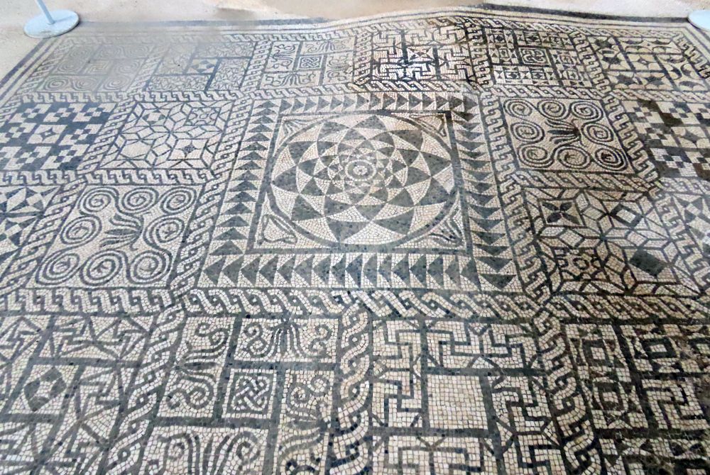 A mosaic of many geometric patterns in black and white.