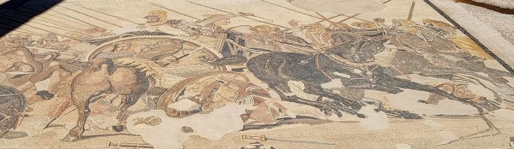 A partial mosaic shows a battle scene with horses.