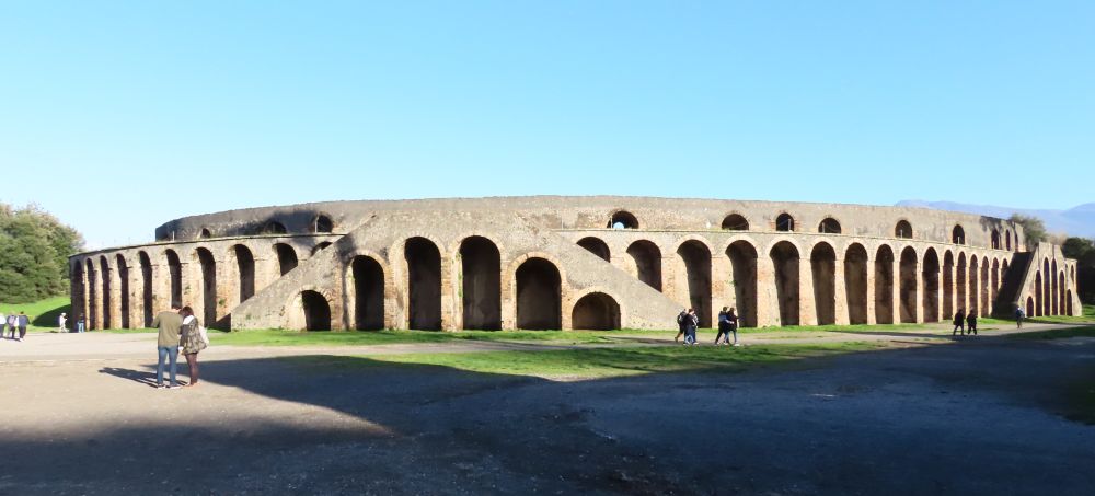 A wide structure with tall arches all around it.