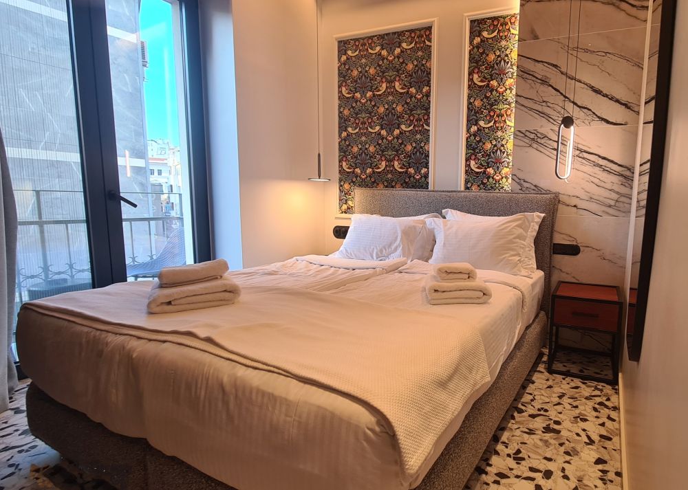 A hotel room with a double bed.