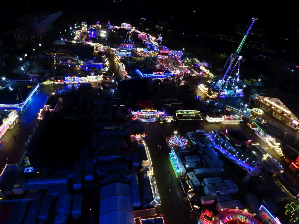 The rows of stalls are all lit with colorful lights.