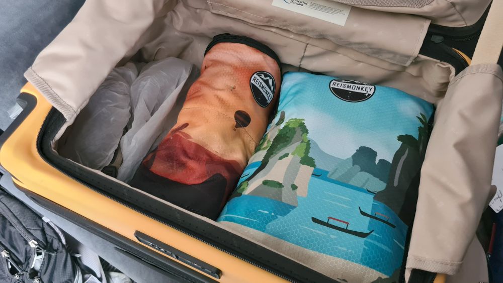 The Level8 bag with a pair of shoes and 2 packing cubes in it.
