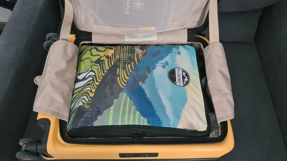 Open Level8 bag filled to the edge with one large compression pack.